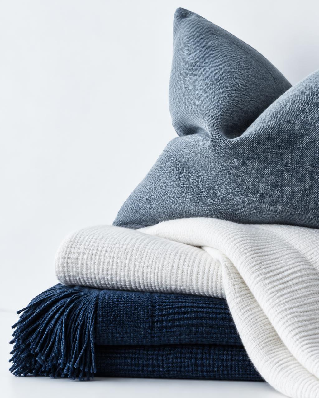 Blue and white woven lifestyle textiles with a soft cushion